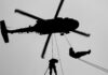 VIDEO: Behind Enemy Lines – American Hunted 50 Hours Silhouette of a helicopter with two individuals being lowered by ropes
