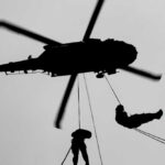VIDEO: Behind Enemy Lines – American Hunted 50 Hours Silhouette of a helicopter with two individuals being lowered by ropes