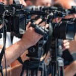 Pentagon Purge Rattles Troops’ Paper television cameras on tripods at a media event