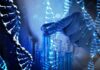 Gloved hand selecting a test tube among blue vials with DNA strands overlay