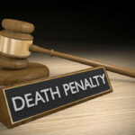 Horror Truck Case Sparks Capital Punishment Clash Gavel beside death penalty sign on desk