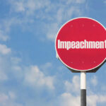Impeachment Bombshell Hits Pentagon Red sign with the word Impeachment against sky