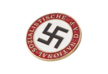 Nazi party badge with swastika on white circle and red border