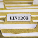 Close-up of a file labeled 'DIVORCE' among other documents
