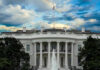 White House Praise, Then the Axe White House with a rainbow in the sky.