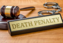 Double Dose, Inmate Lives Gavel handcuffs and death penalty sign on table