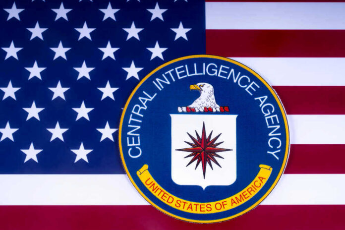 CIA emblem over United States flag background.