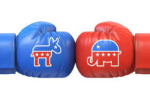 Blue donkey and red elephant boxing gloves facing off.