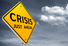 Chaos Erupts: Curfews, 2,400 Nabbed A yellow warning sign indicating a crisis ahead