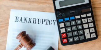 Bankruptcy document with gavel and calculator on desk