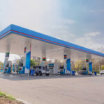 Gas-Station Meals Undercut Fast Food A modern gas station with fuel pumps and parked vehicles
