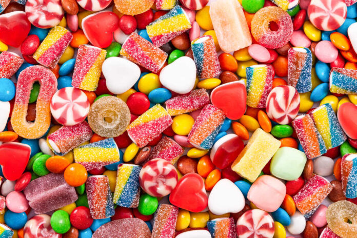 Colorful,Chocolate,Dragee,And,Different,Candy.,Top,View. Assorted colorful candies and sweets scattered in a pile