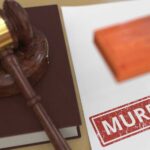 Judge's gavel on a law book beside a stamped document