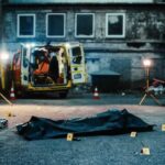 Drive Home Explodes Into Horror Police investigation at a crime scene with a covered body and evidence markers