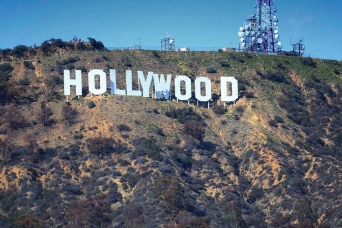 shutterstock_2420199795 Hollywood sign on hillside with communication towers.