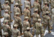 White House Ambush Shocks D.C. Timmy Jernigan among soldiers marching in formation on a street