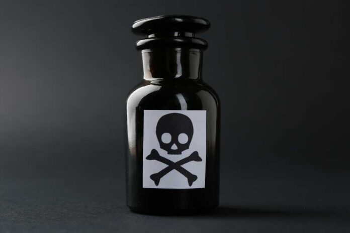 Bottle,Of,Poison,With,Warning,Sign,On,Grey,Background,,Closeup Dark glass bottle with skull and crossbones label