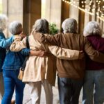Longevity Trick Hiding In Plain Sight Group of elderly friends walking arm in arm outdoors