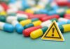 Capsules and a yellow warning sign