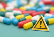 Capsules and a yellow warning sign