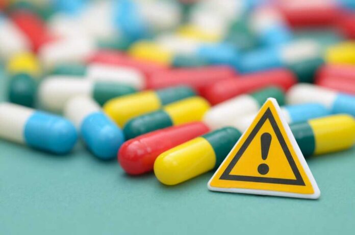 Capsules and a yellow warning sign