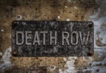 Death Row By Choice? Weathered metal sign reading 'DEATH ROW' on a wall