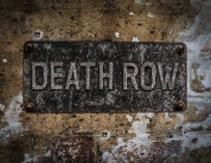 shutterstock_533872477 Weathered metal sign reading 'DEATH ROW' on a wall