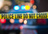 River Deaths Spark Serial Killer Fears Police tape and lights at crime scene.